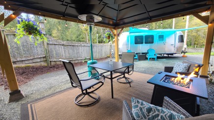 Airstream exterior with covered patio and fire-pit